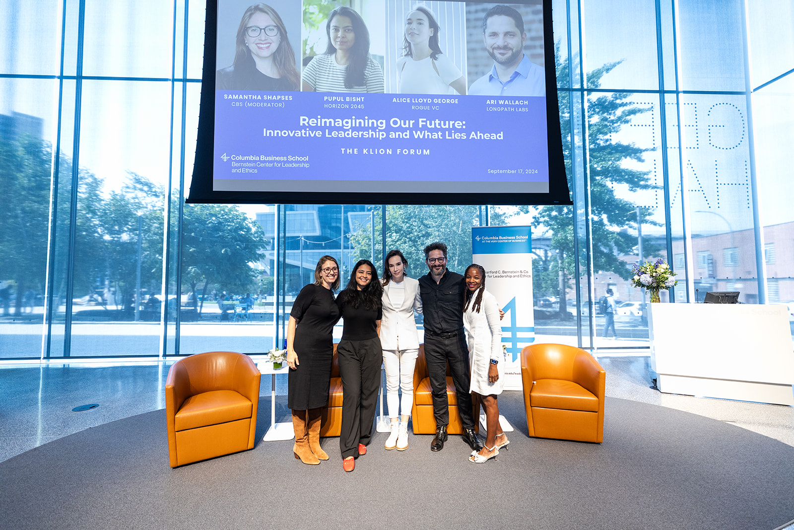 Panelists and moderator pose for a photo.