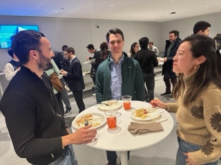 People eat snacks at the post-panel reception