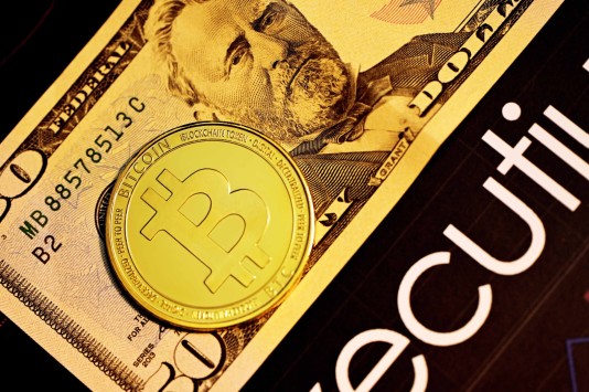 Image of a $50 bill and a Bitcoin