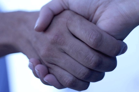 Two hands shaking one another