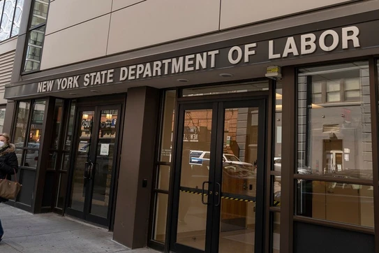 A masked pedestrian outside the New York State Department of Labor