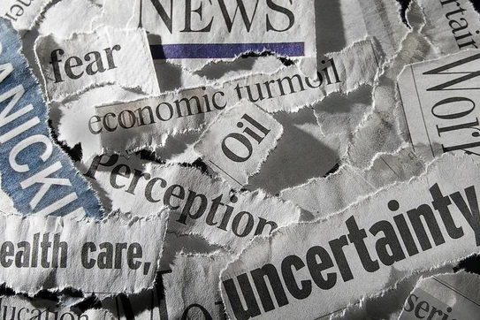 Words clipped from a newspaper that read "fear," "uncertainty," "economic turmoil," and such