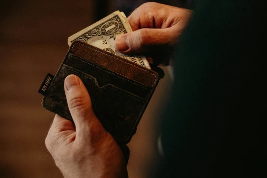 taking dollar bill out of wallet
