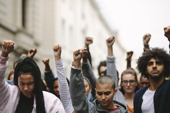 A group of Black Lives Matter protestors stand on a crowded street