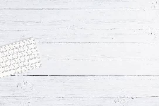 A white keyboard sitting on a white tabletop. Photo by iMattSmart on Unsplash
