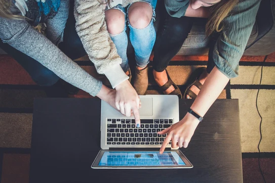 Three person pointing the silver laptop computer photo. Photo by John Schnobrich on Unsplash.