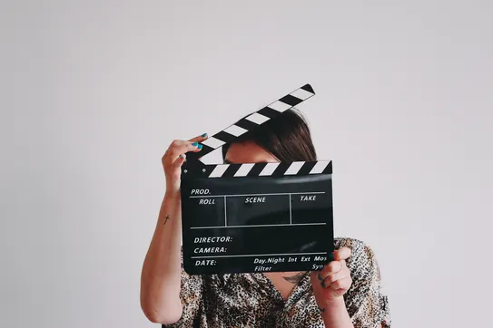 person holding a clapperboard