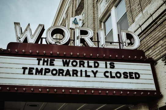 theater marquee saying the world is temporarily closed