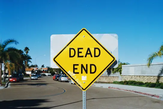 A photograph of a street sign reading "dead end"