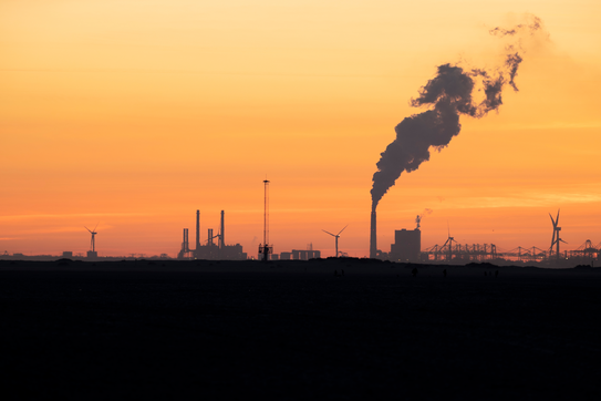 An industrial plant with a smokestack 