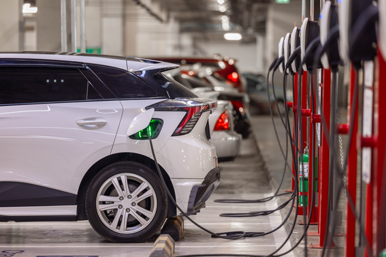 Electric cars charging in a garage.