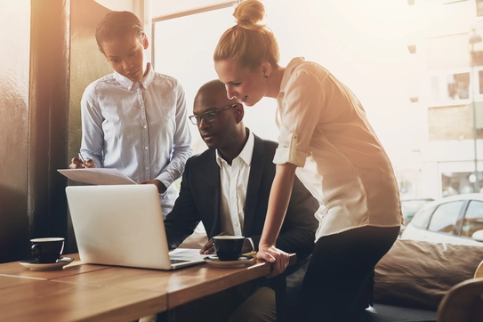 People working together in front of a computer