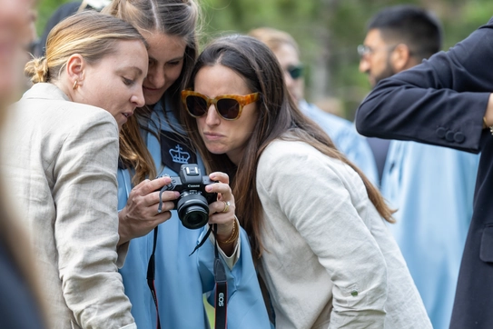 Photo of graduate with camera