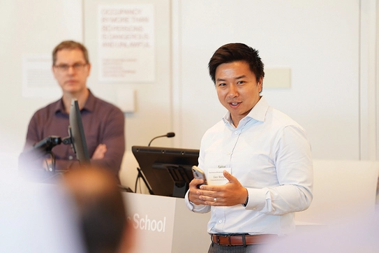 Professor Dan Wang speaking before a class