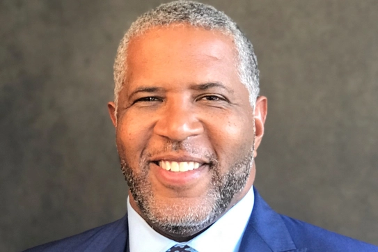 Headshot of Robert F. Smith ‘94 wearing a white collared button-down shirt and a blue suit jacket