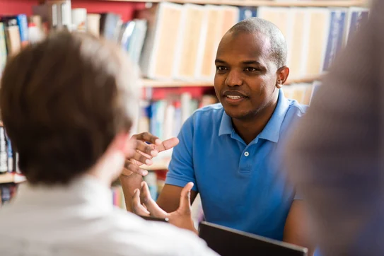 A group of students discuss a problem during class