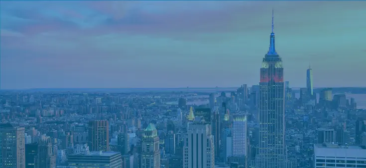 Fall 2025 Climate Week website header image of the Empire State Building in red, white, and blue lights