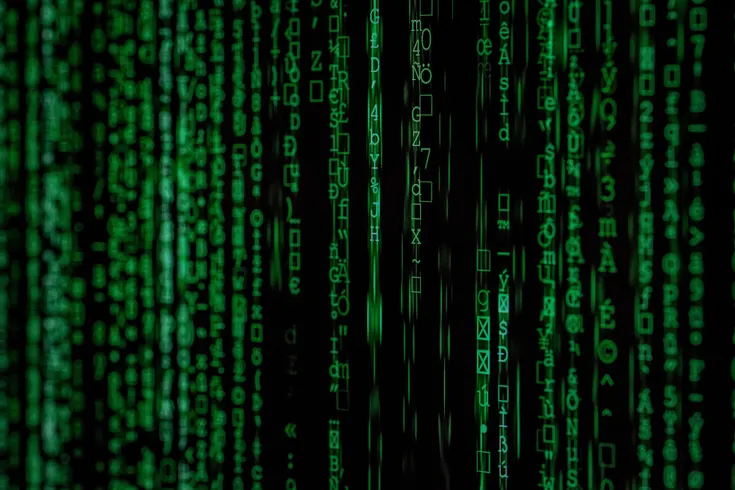 Hacker binary attack code. Made with Canon 5d Mark III and analog vintage lens, Leica APO Macro Elmarit-R 2.8 100mm (Year: 1993). Photo by Markus Spiske on Unsplash.  