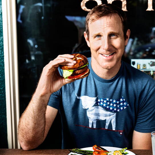 Ethan Brown holding a Beyond Meat burger