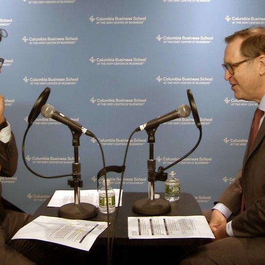 Glenn Hubbard with Fahad Ahmed sitting at a desk with microphones